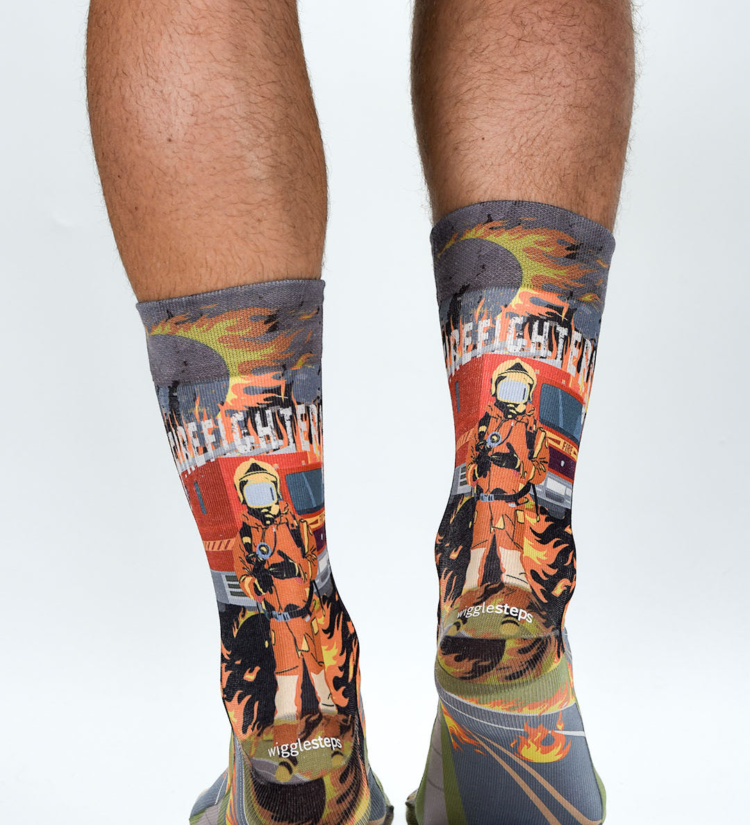 Colorful socks with firefighter design worn by a person on a white background