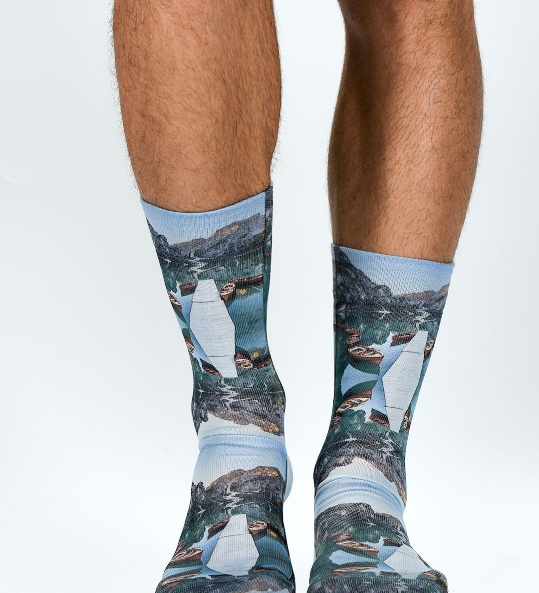 Socks with nature-themed design worn by a person on a white background