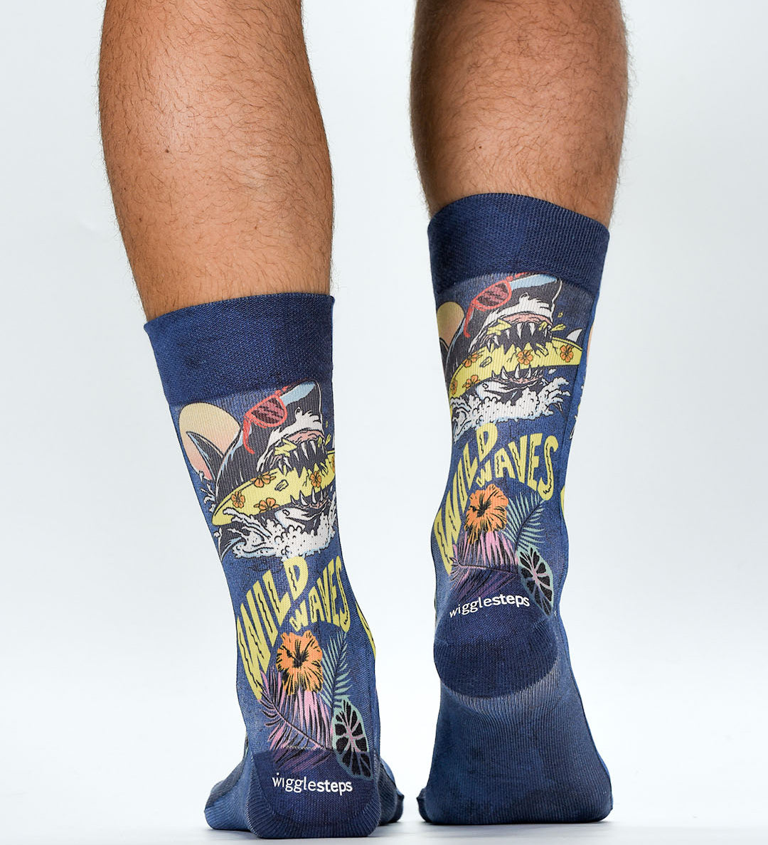 Navy socks with shark and surf design worn by a person on a white background