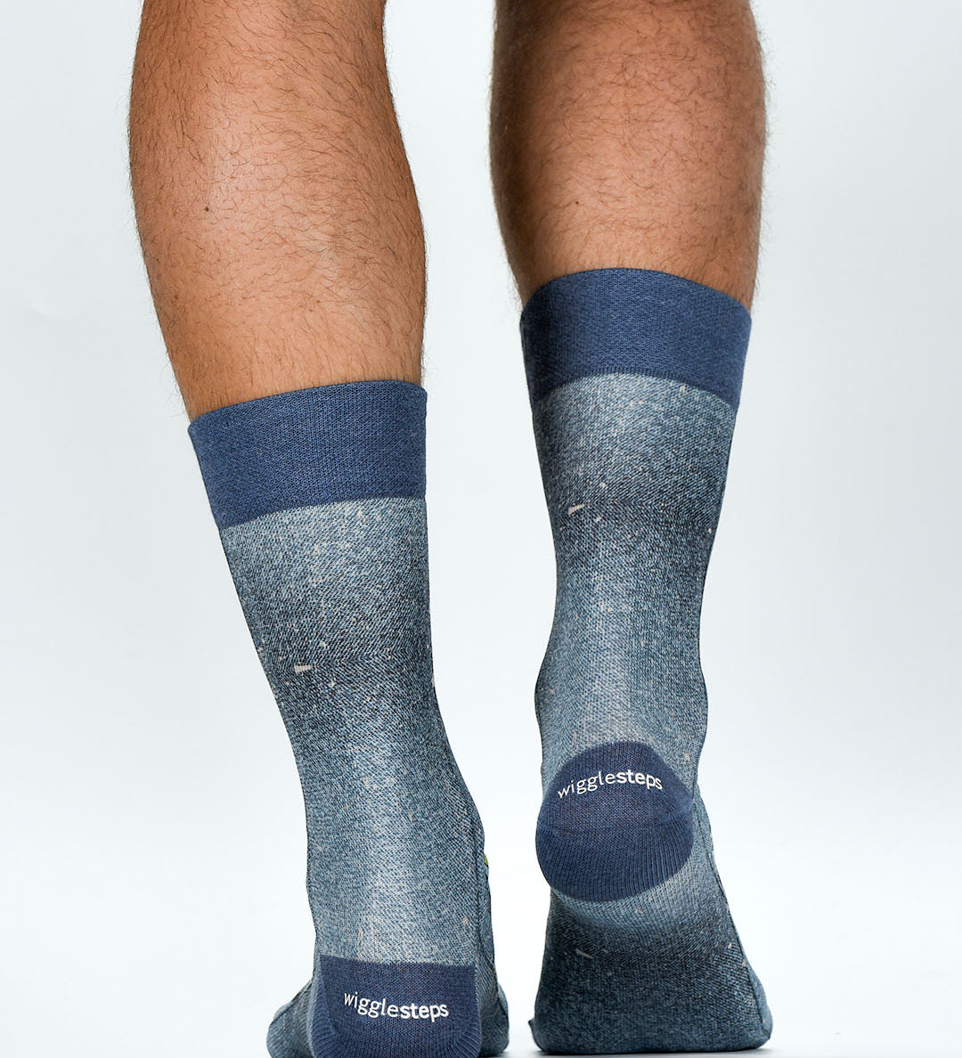 Gray socks with blue accents worn by a person on a white background