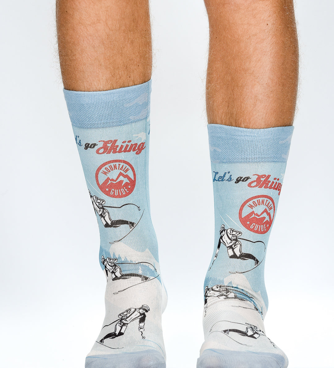Light blue socks with graphic designs and text on a white background