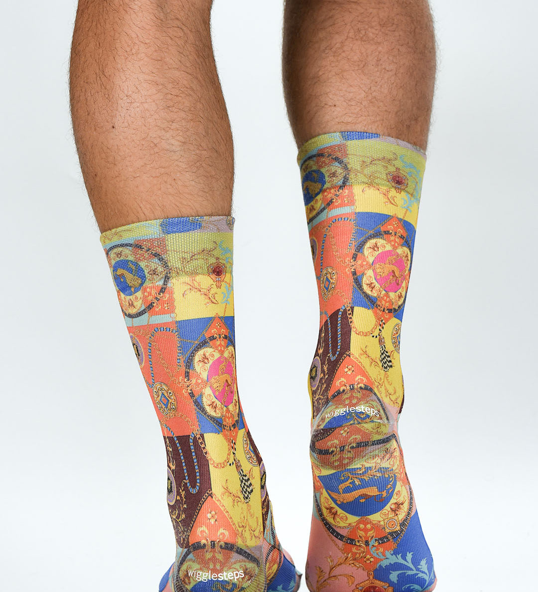 Colorful patterned socks worn by a person on a white background