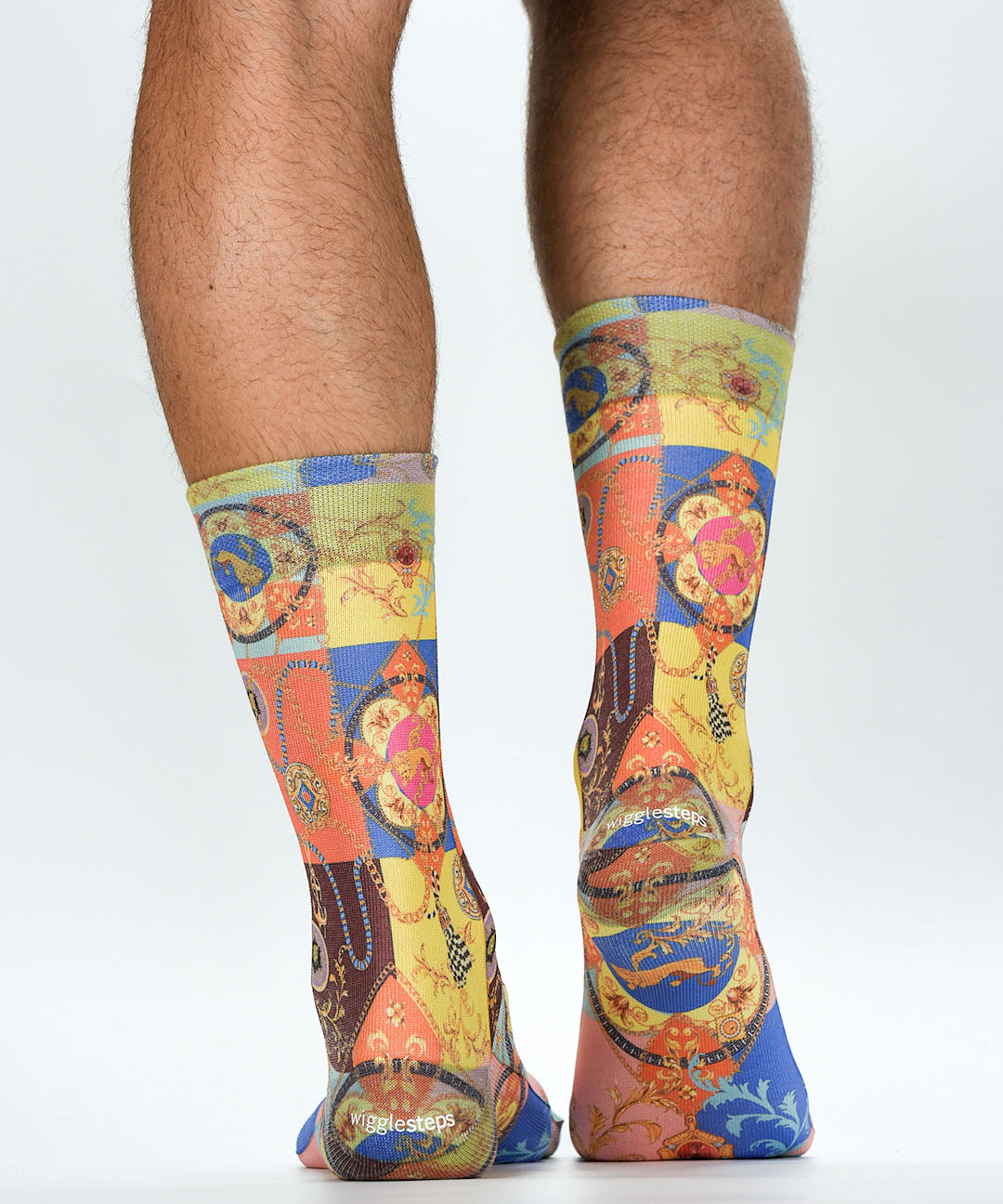 Colorful patterned socks worn by a person on a white background