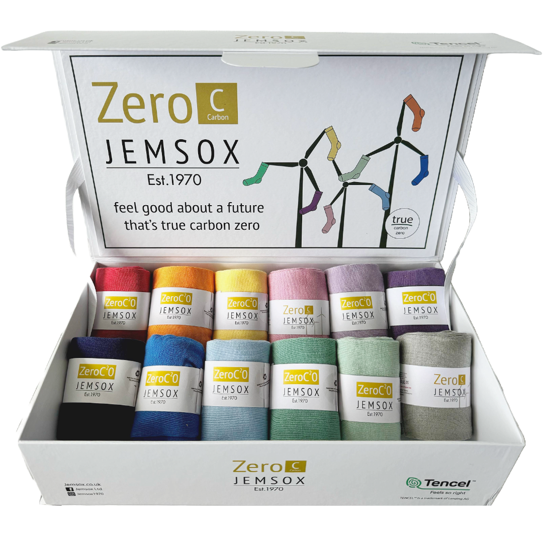 A box of Jemsox Carbon Zero socks, displaying multiple pairs of colorful socks inside the open box with the brand's logo and the phrase 'Feel good about a future that's true carbon zero' on the cover.