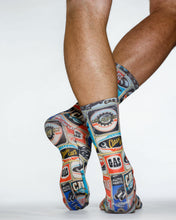 Colorful graphic socks worn by a person on a white background
