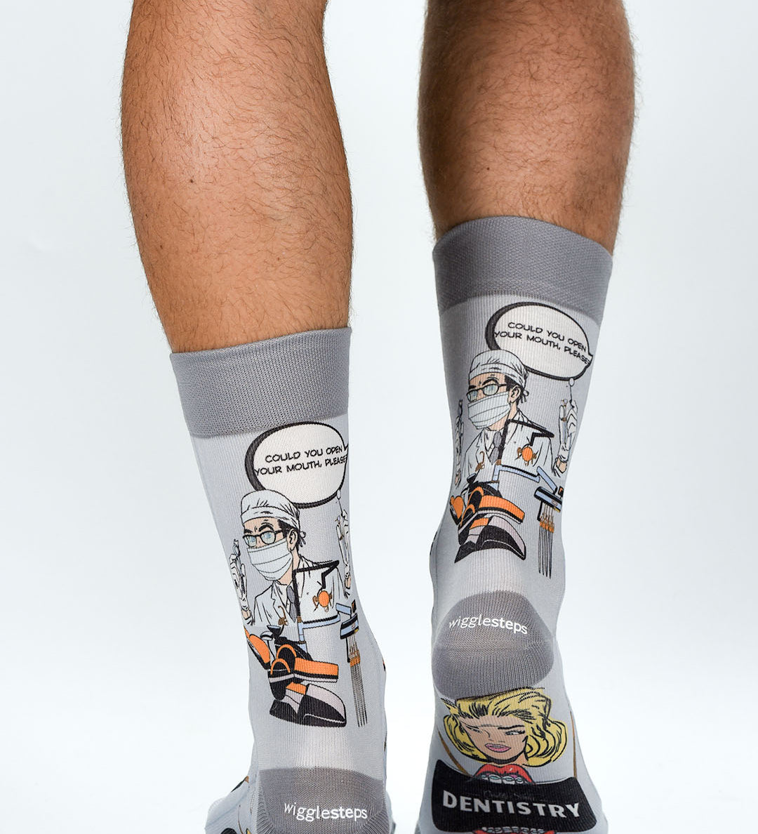 Gray socks with dental-themed designs and text on a white background