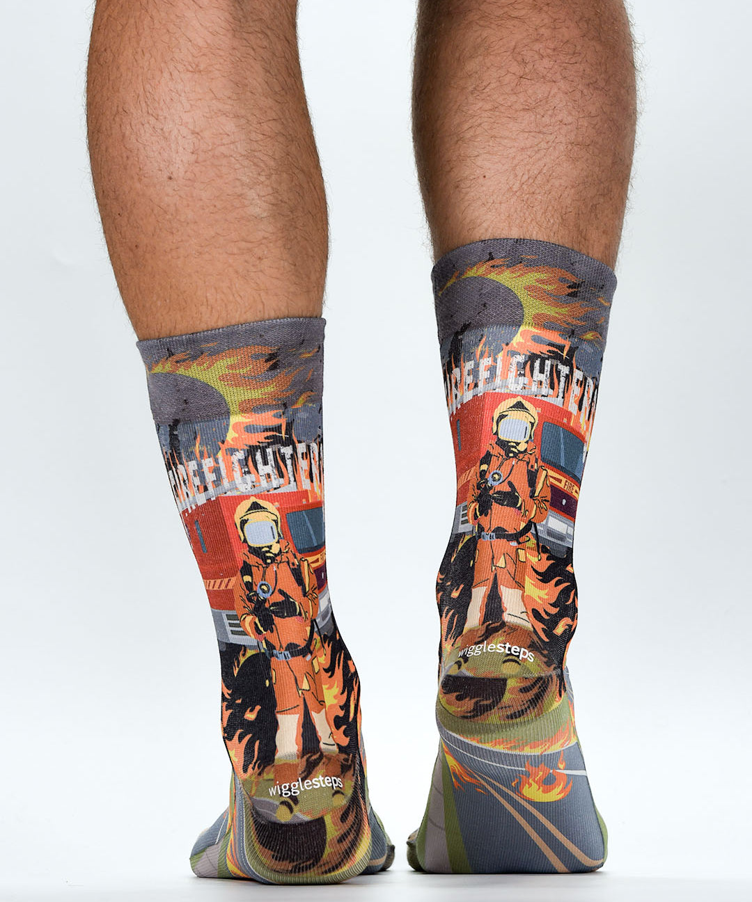 Colorful socks with firefighter design worn by a person on a white background