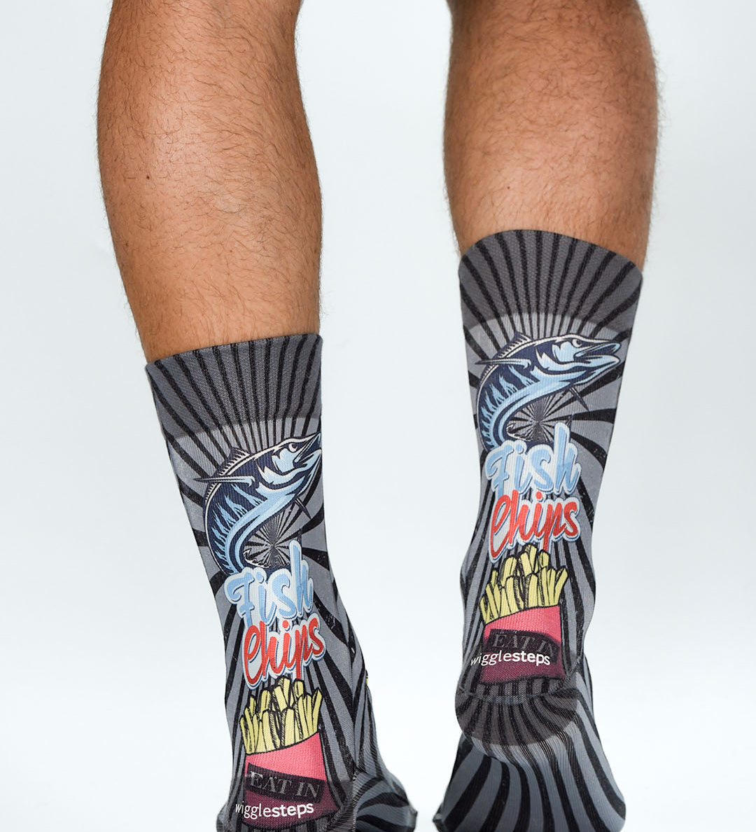 Person wearing socks with fish and chips design on a white background