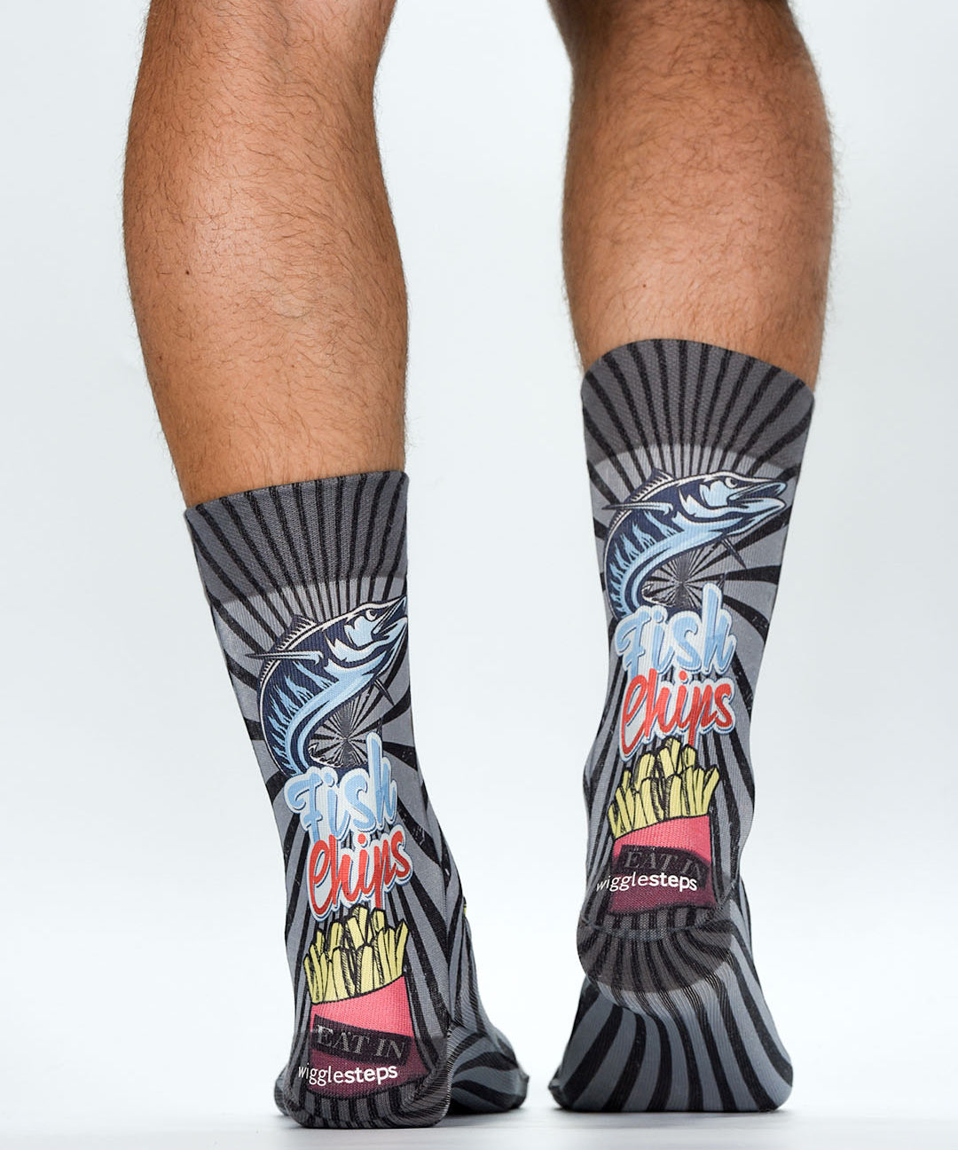 Person wearing socks with fish and chips design on a white background