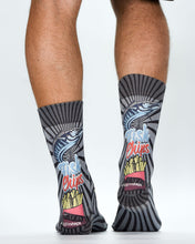Person wearing socks with fish and chips design on a white background