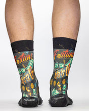 Socks with 'Fortune' theme and black cuffs worn by a person on a white background