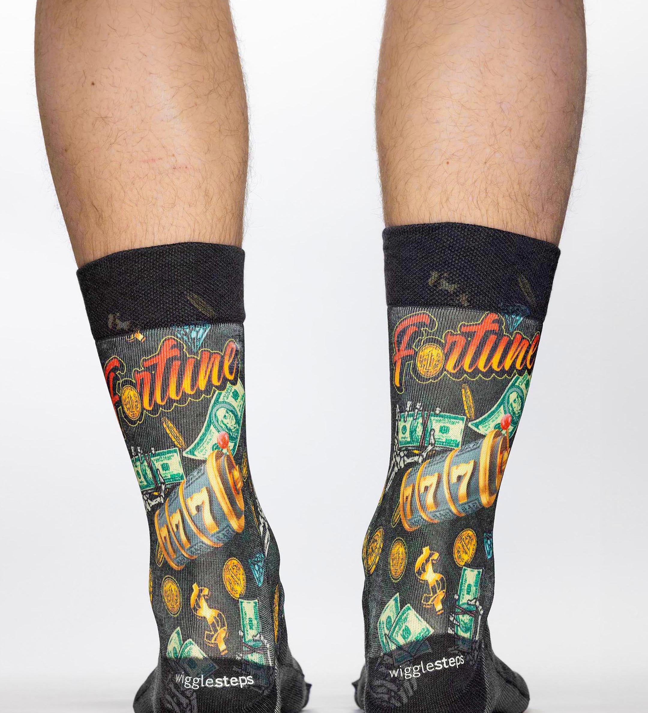 Socks with 'Fortune' theme and black cuffs worn by a person on a white background