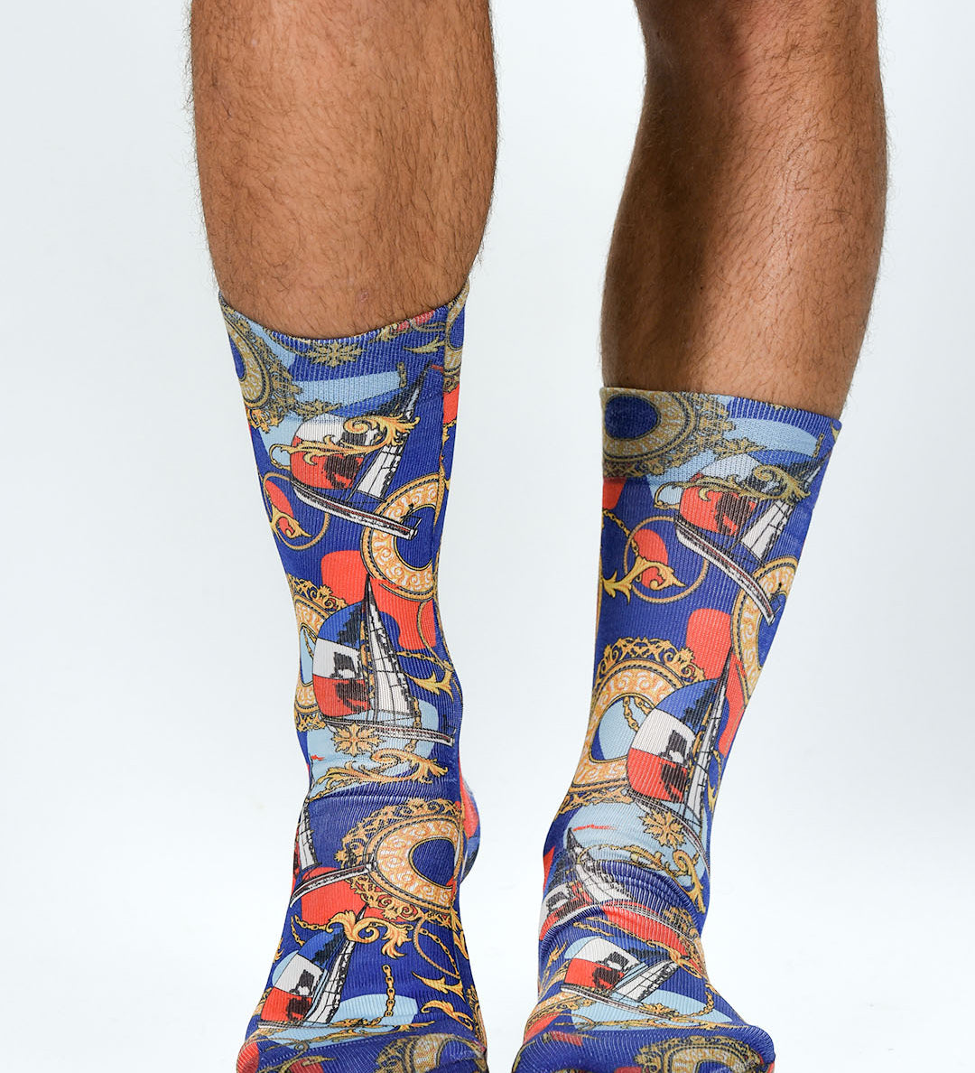 Colorful patterned socks worn by a person on a white background