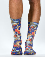 Colorful patterned socks worn by a person on a white background