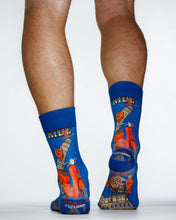 Blue socks with scooter design worn by a person on a white background
