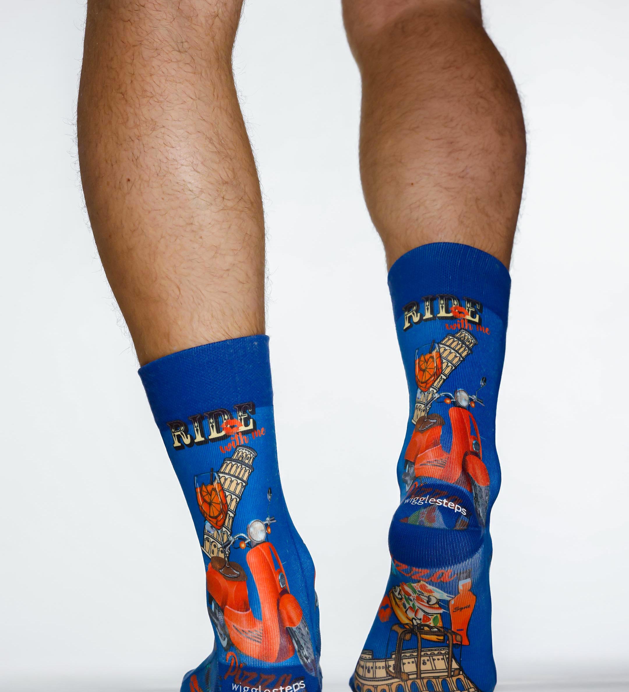 Blue socks with scooter design worn by a person on a white background
