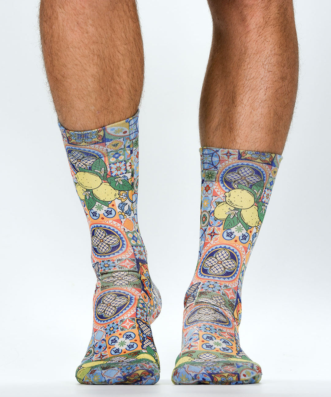 Colorful patterned socks worn by a person on a white background
