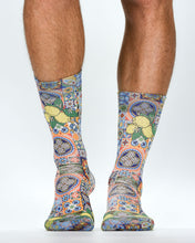 Colorful patterned socks worn by a person on a white background