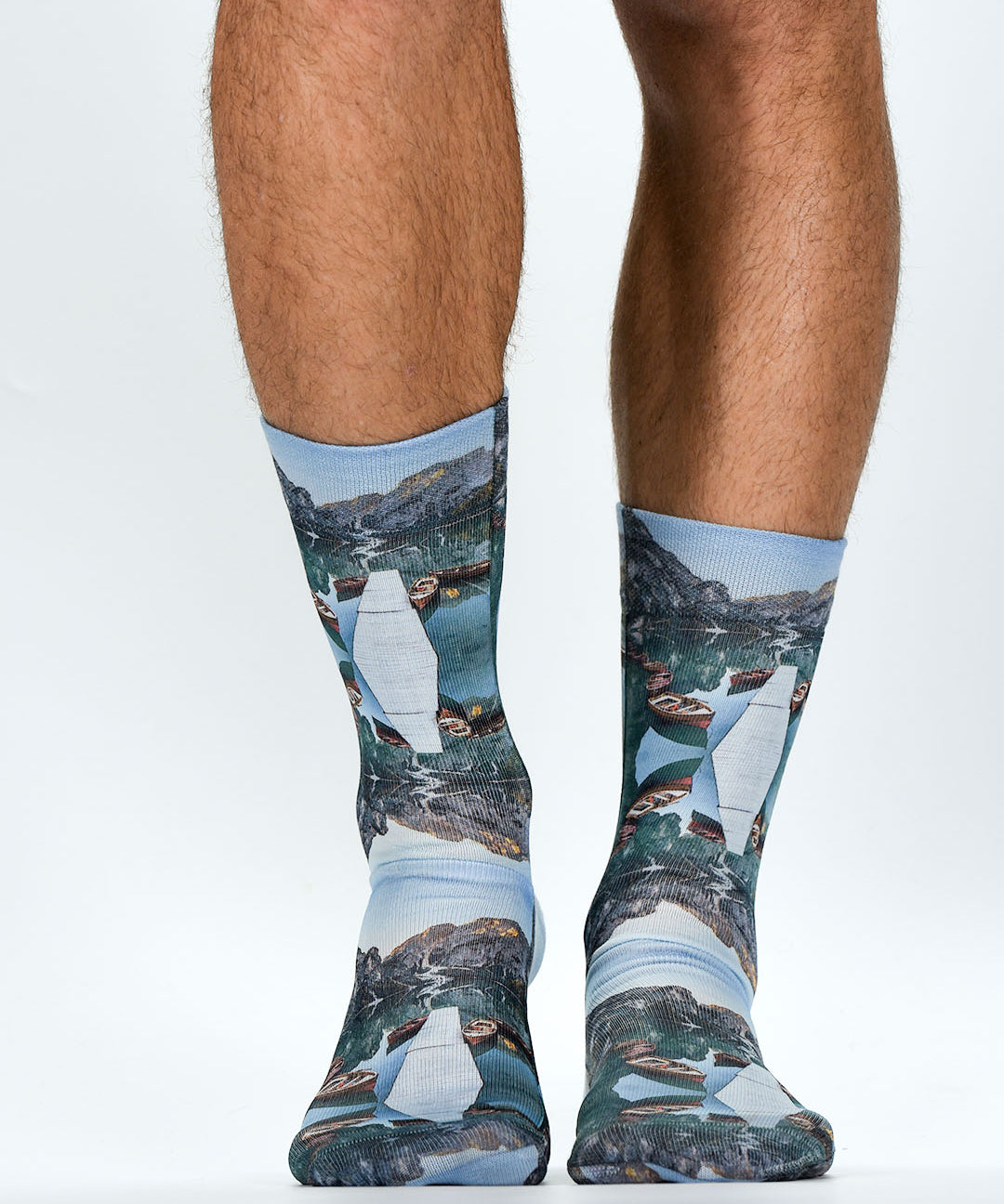 Socks with nature-themed design worn by a person on a white background