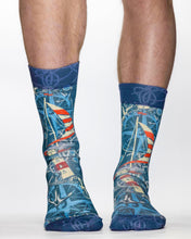Blue socks with maritime design worn by a person on a white background