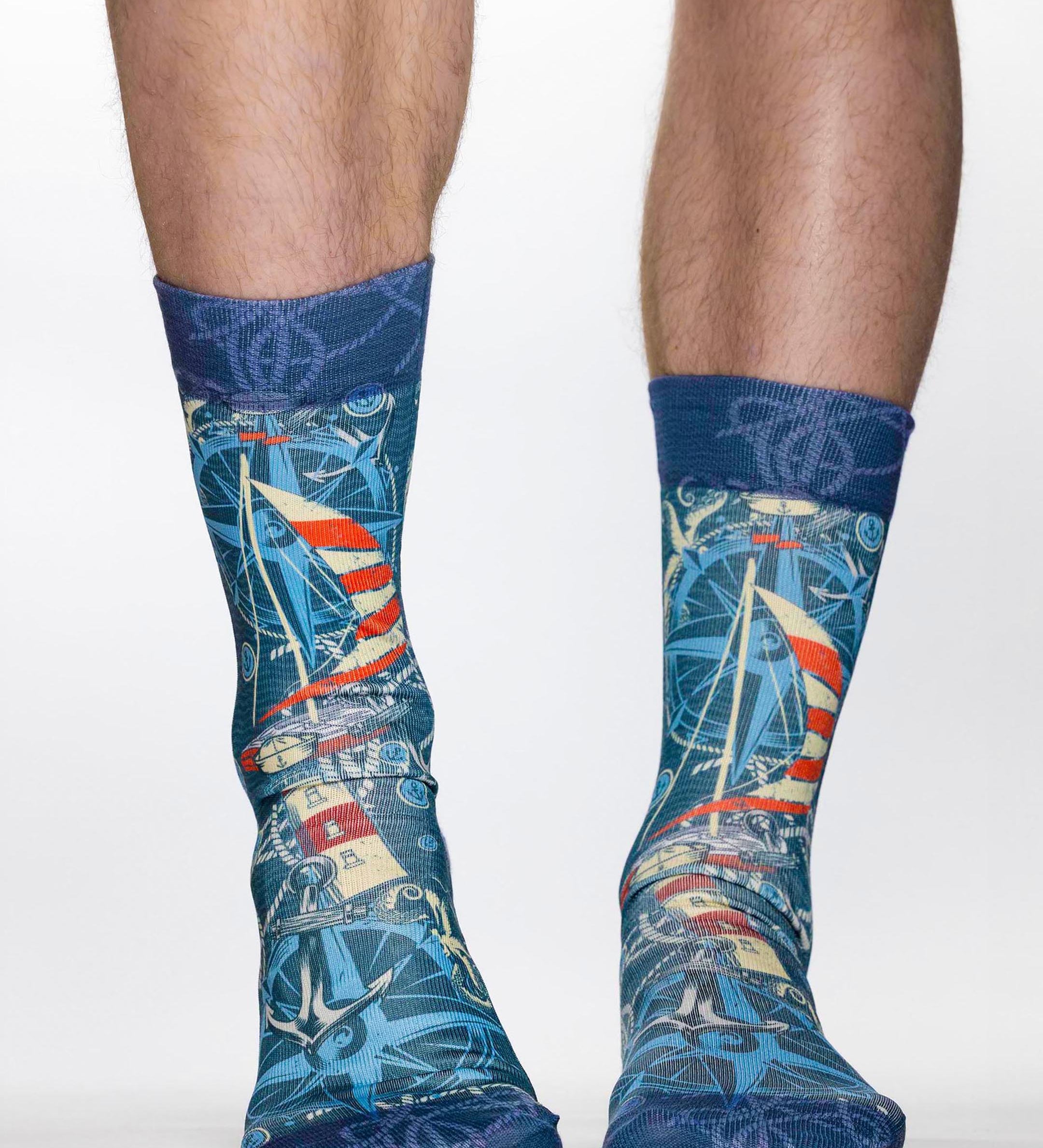 Blue socks with maritime design worn by a person on a white background