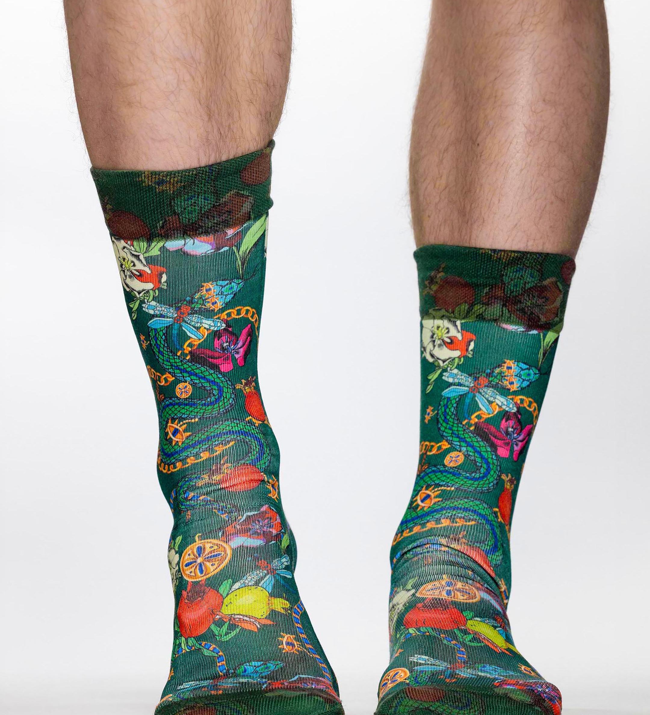 Colorful patterned socks worn by a person on a white background