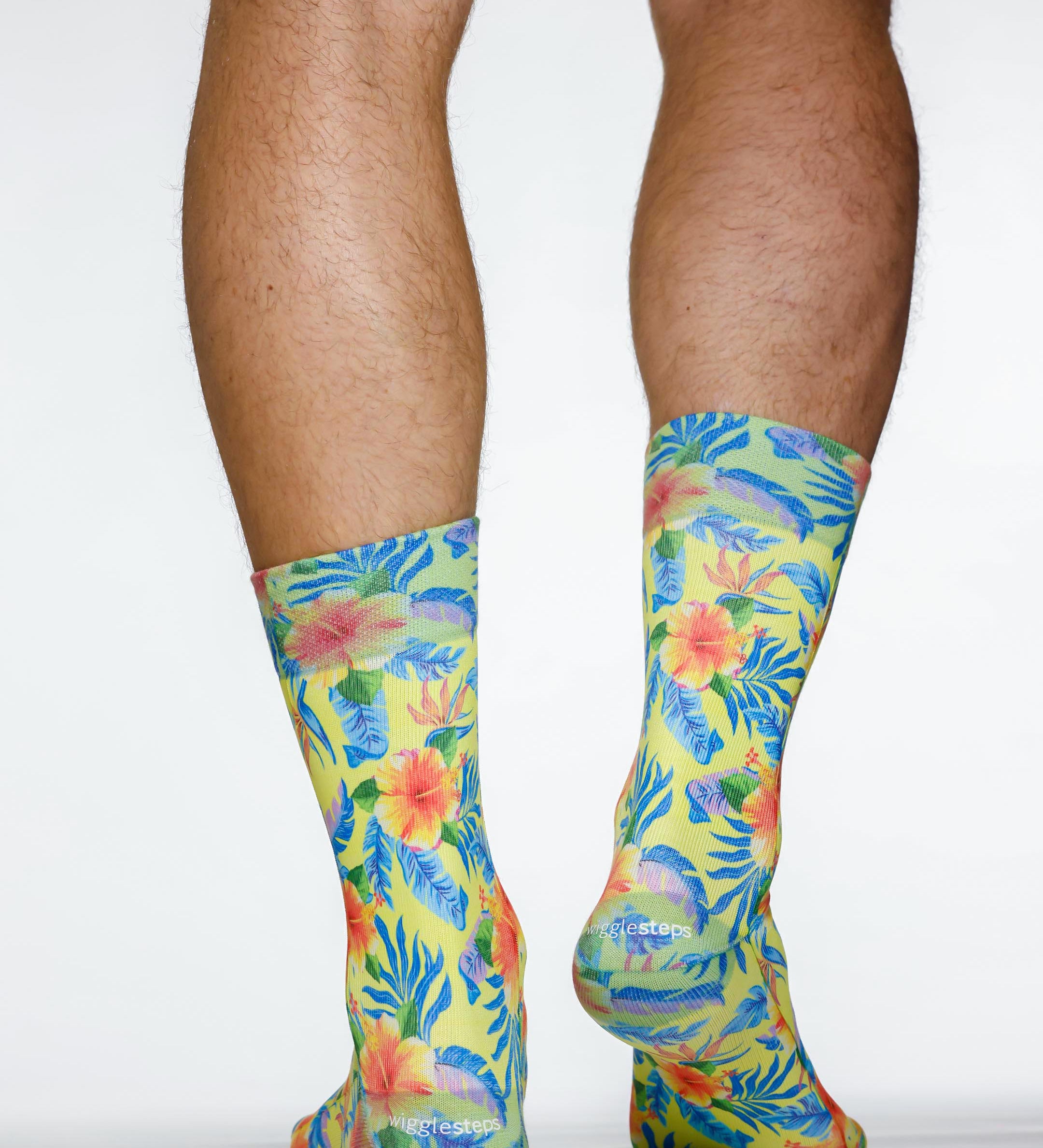 Colorful tropical leaf patterned socks on a plain background