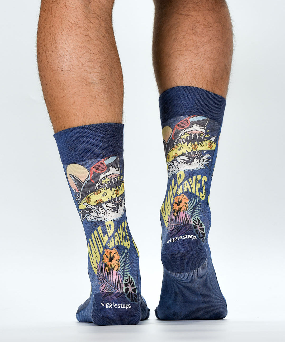 Navy socks with shark and surf design worn by a person on a white background
