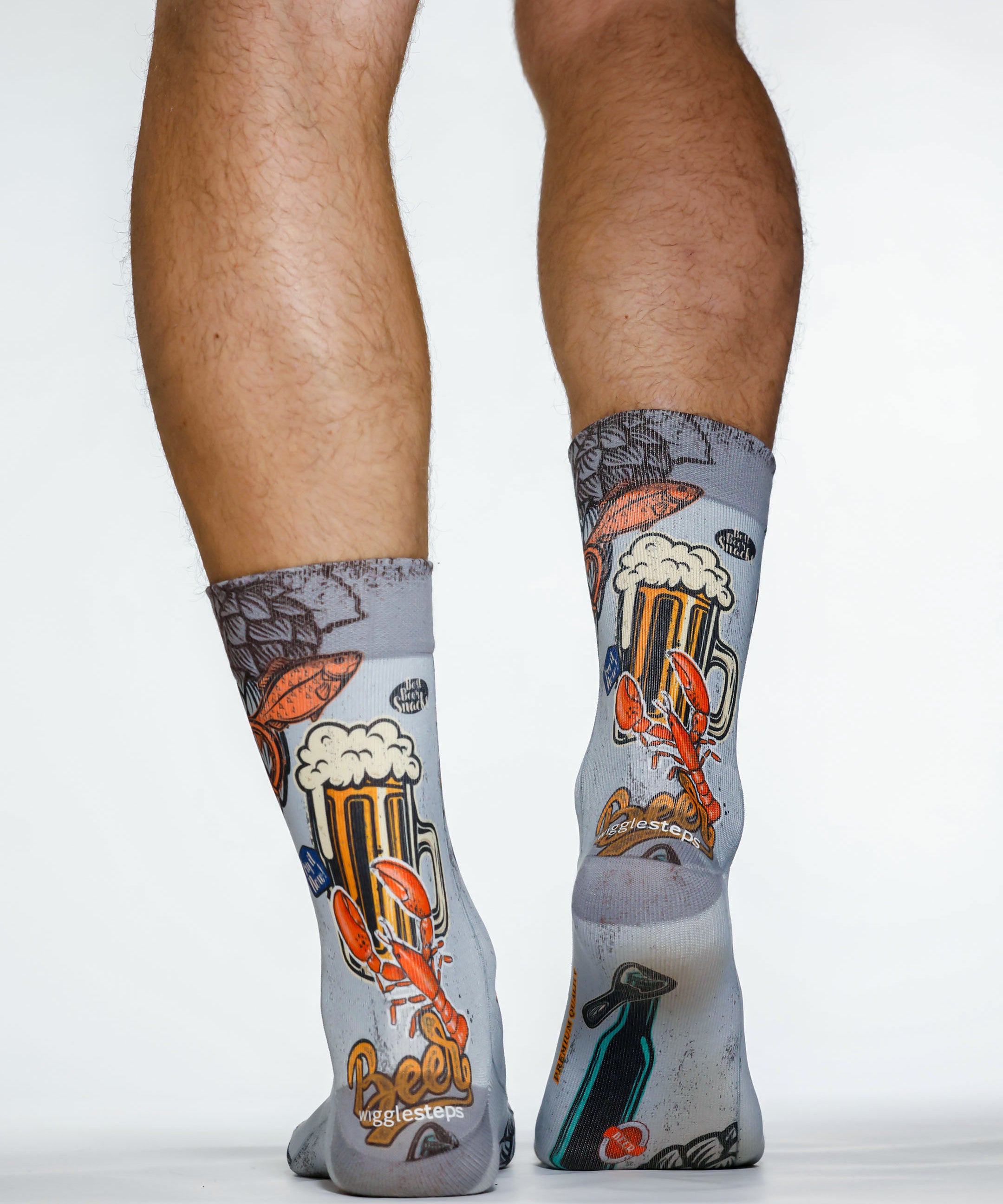 Gray socks with beer-themed design worn by a person on a white background