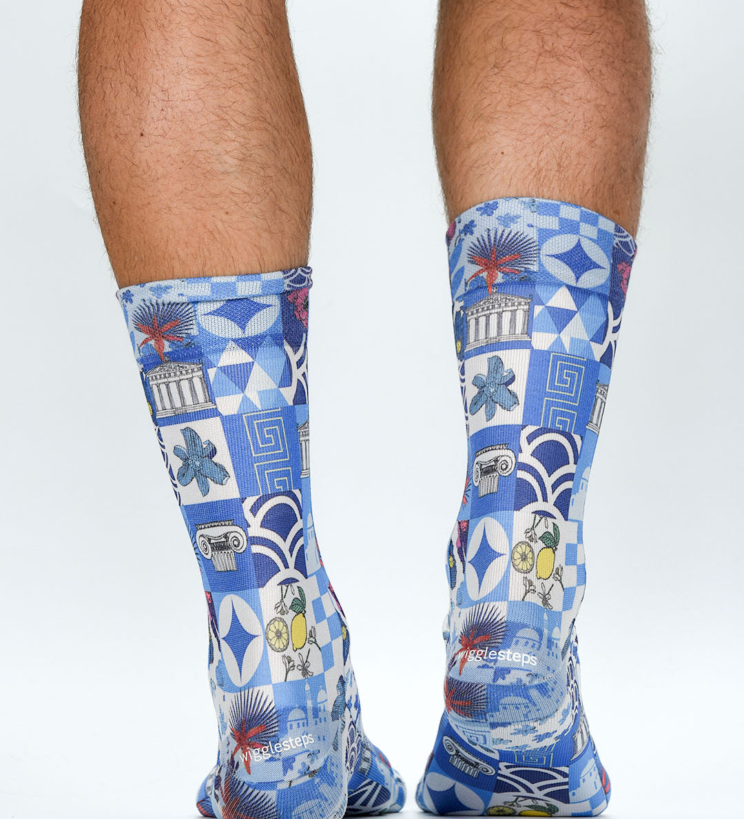 Blue patterned socks worn by a person on a white background