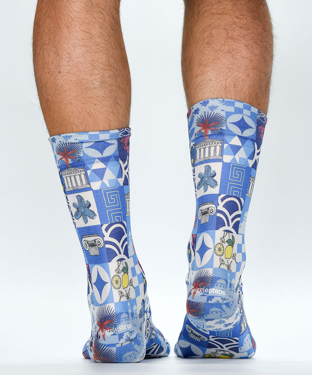 Blue patterned socks worn by a person on a white background