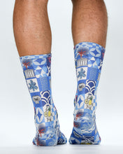 Blue patterned socks worn by a person on a white background