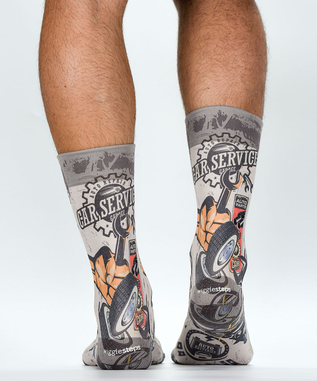 Gray socks with car service design worn by a person on a white background