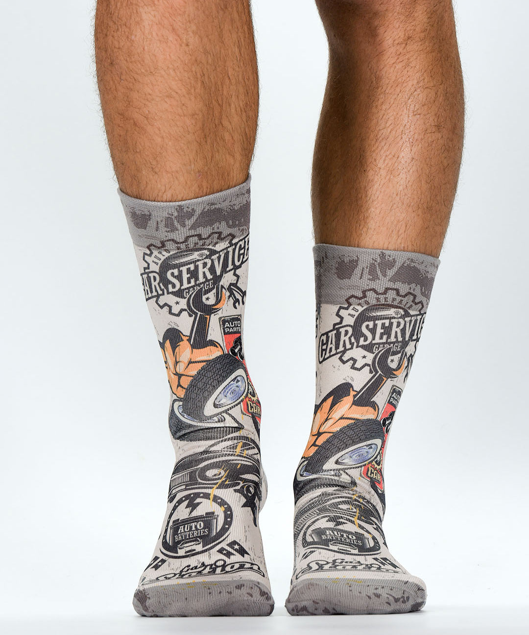 Gray socks with mechanical design worn by a person on a white background