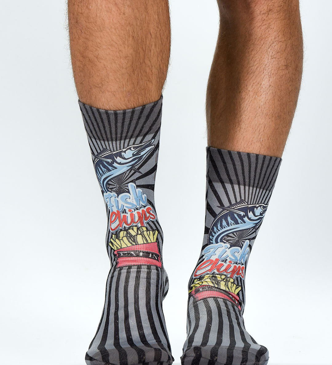 Colorful socks with abstract designs worn by a person on a white background