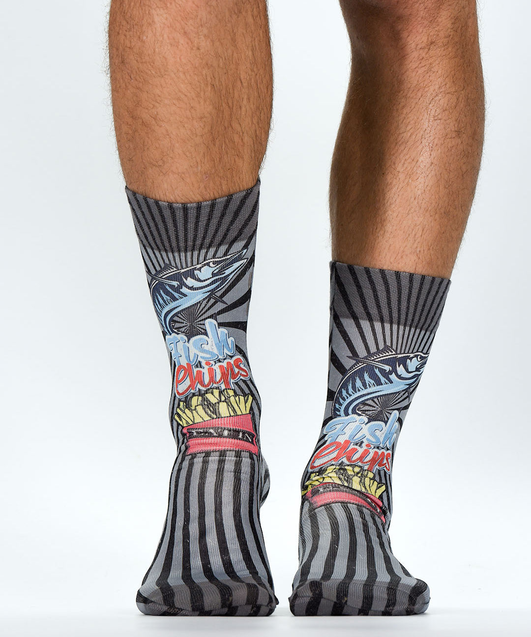 Colorful socks with abstract designs worn by a person on a white background