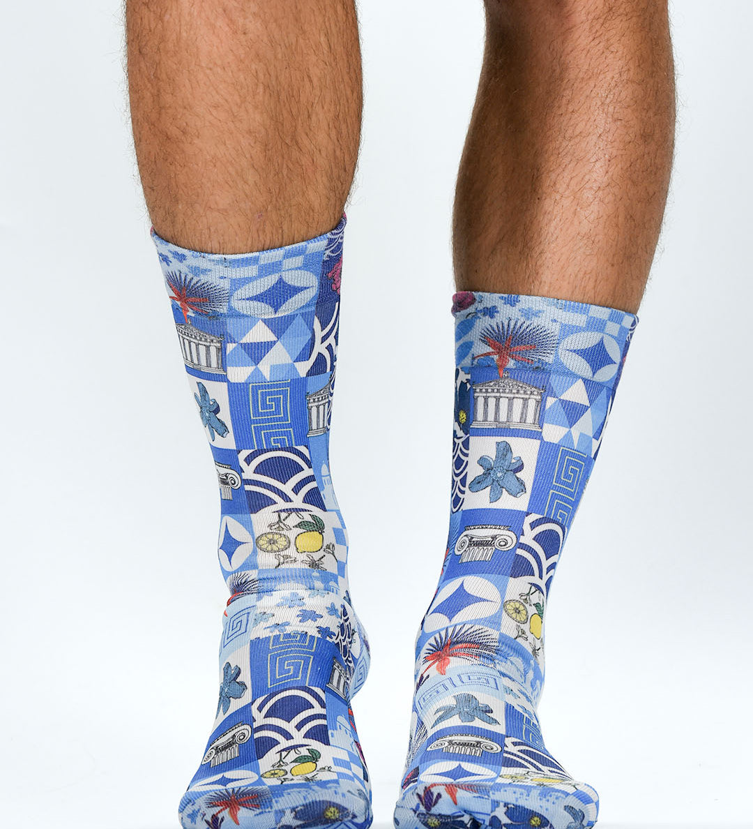 Blue patterned socks worn by a person on a white background