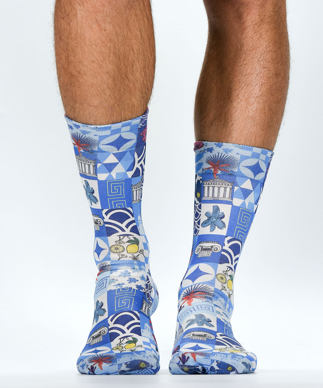 Blue patterned socks worn by a person on a white background