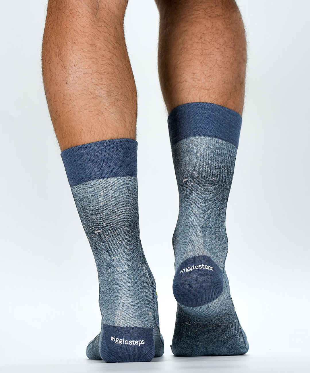 Gray socks with blue accents worn by a person on a white background