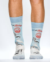 Light blue socks with graphic designs and text on a white background