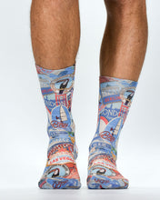 Colorful travel-themed socks worn by a person on a white background
