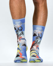 Colorful socks with a design of a person holding a flag on a white background